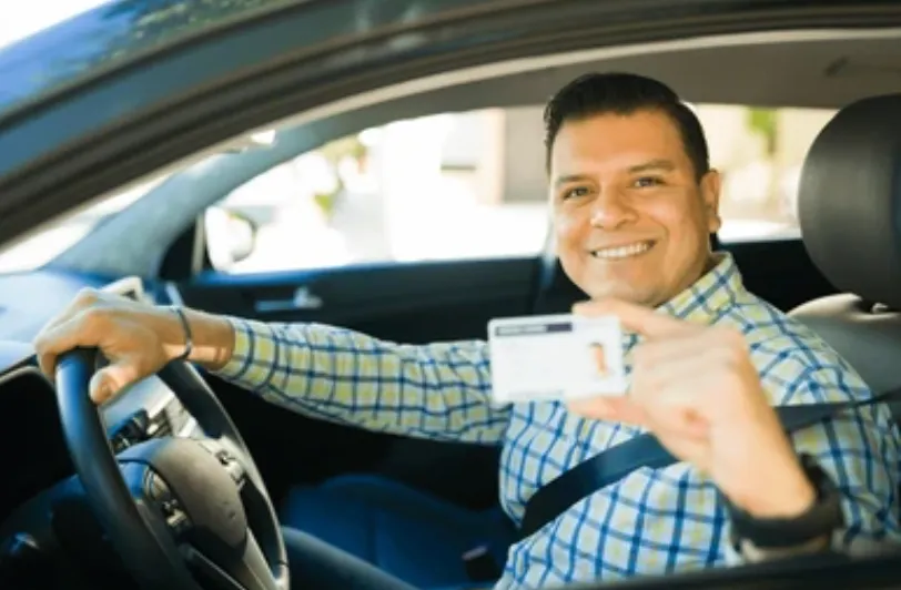 Happy driver showing insurance savings